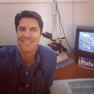 Photograph of Peter Kahler examining blood cells